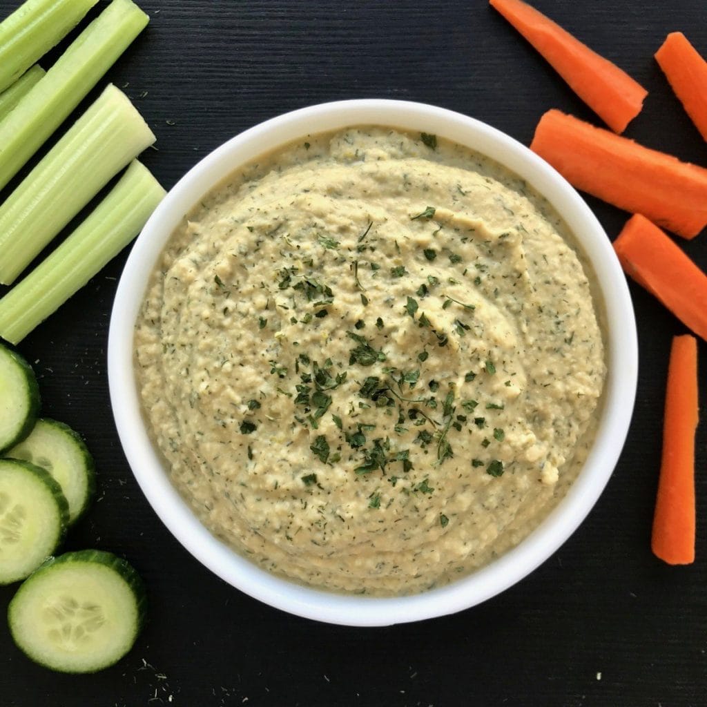 Dill pickle hummus with carrots, celery, and cucumber.