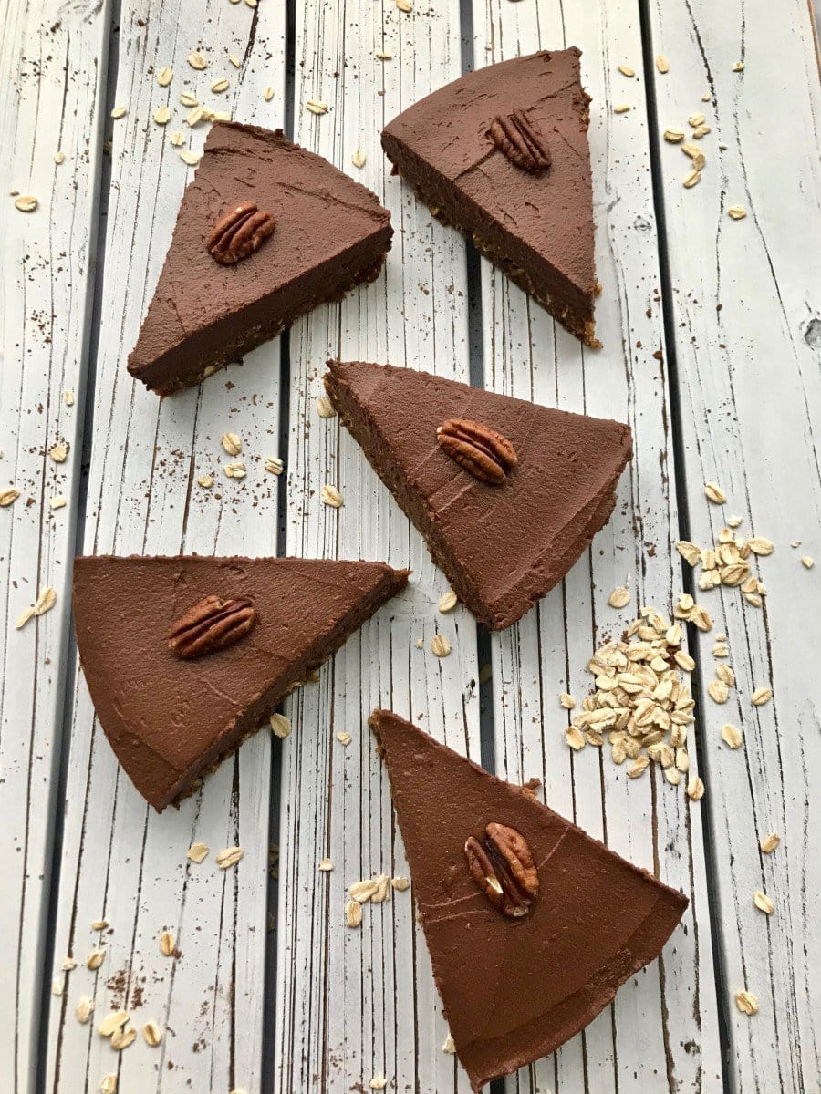 Slices of chocolate sweet potato pie with pecans on top.