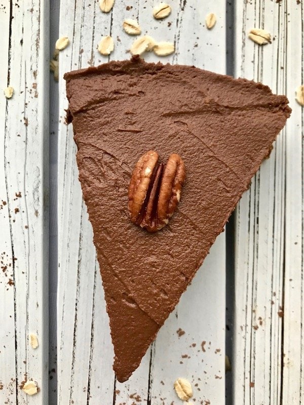 One slice of chocolate pie with a pecan on top.