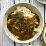 Mushroom gravy on a bowl of mashed potatoes.