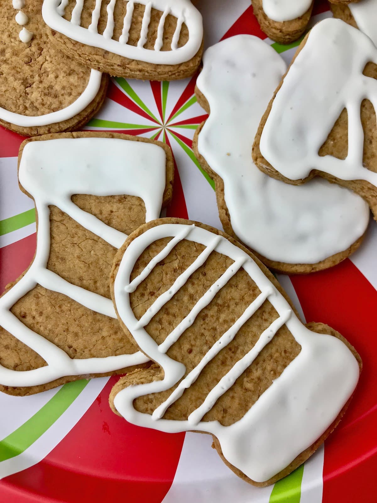 Christmas cookies with white frosting on a plate.