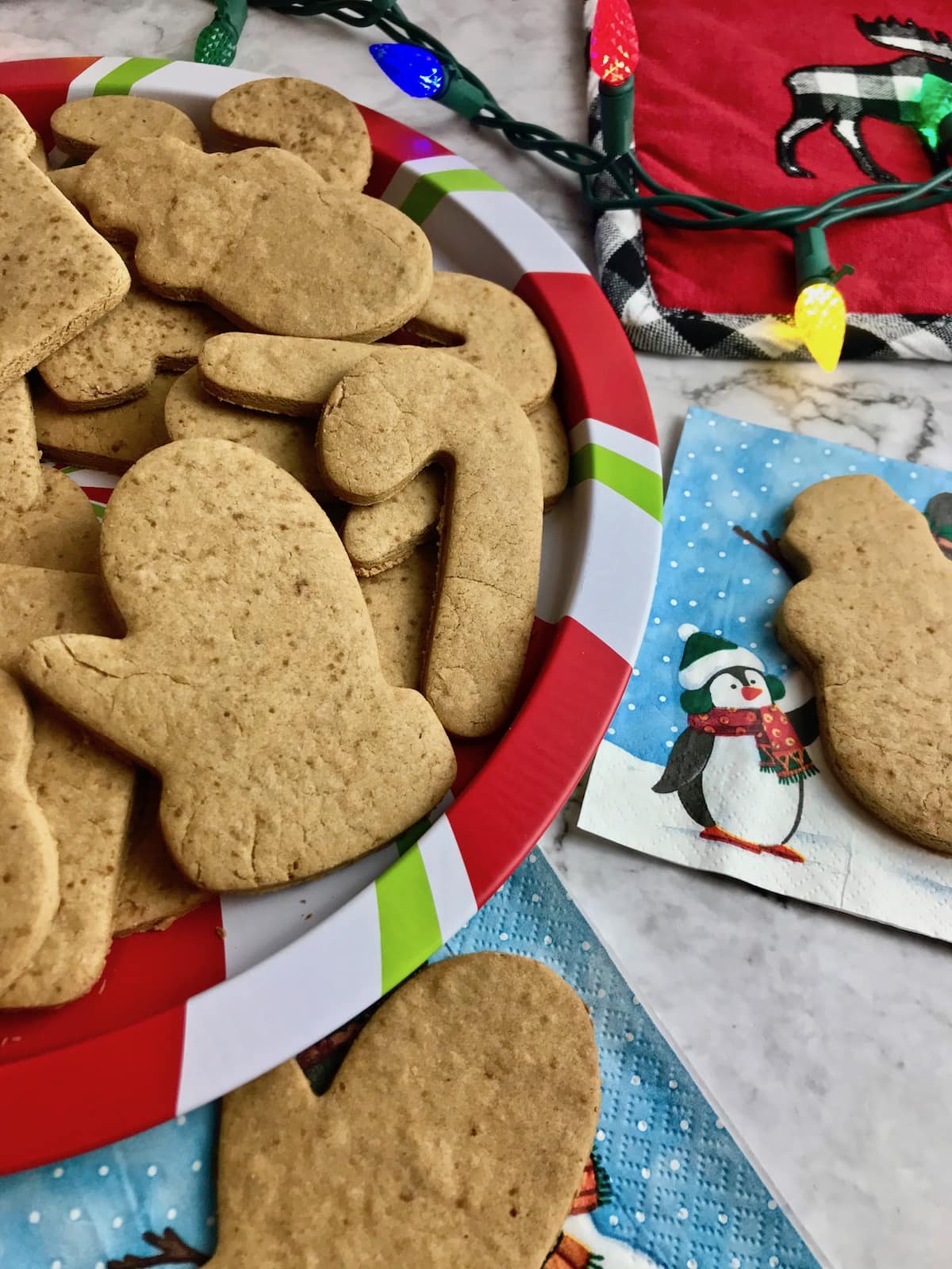 Coconut sugar cookies on a Christmas coloured plate and Christmas napkins. 