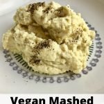 Mashed cauliflower on a plate with text that says, "Vegan Mashed Cauliflower."