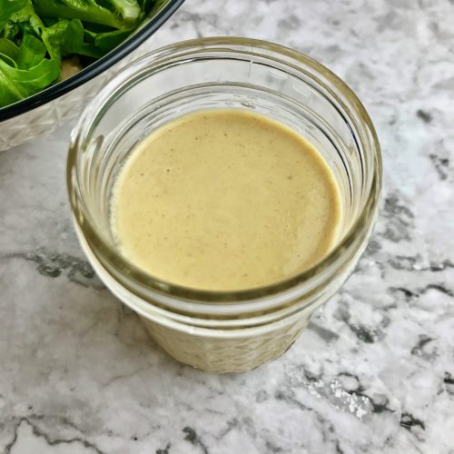 Jar of maple dijon dressing.