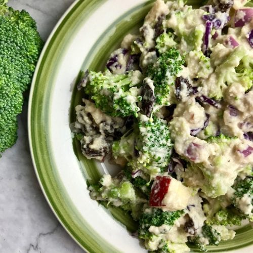 Half of a plate of broccoli salad with a creamy dressing.