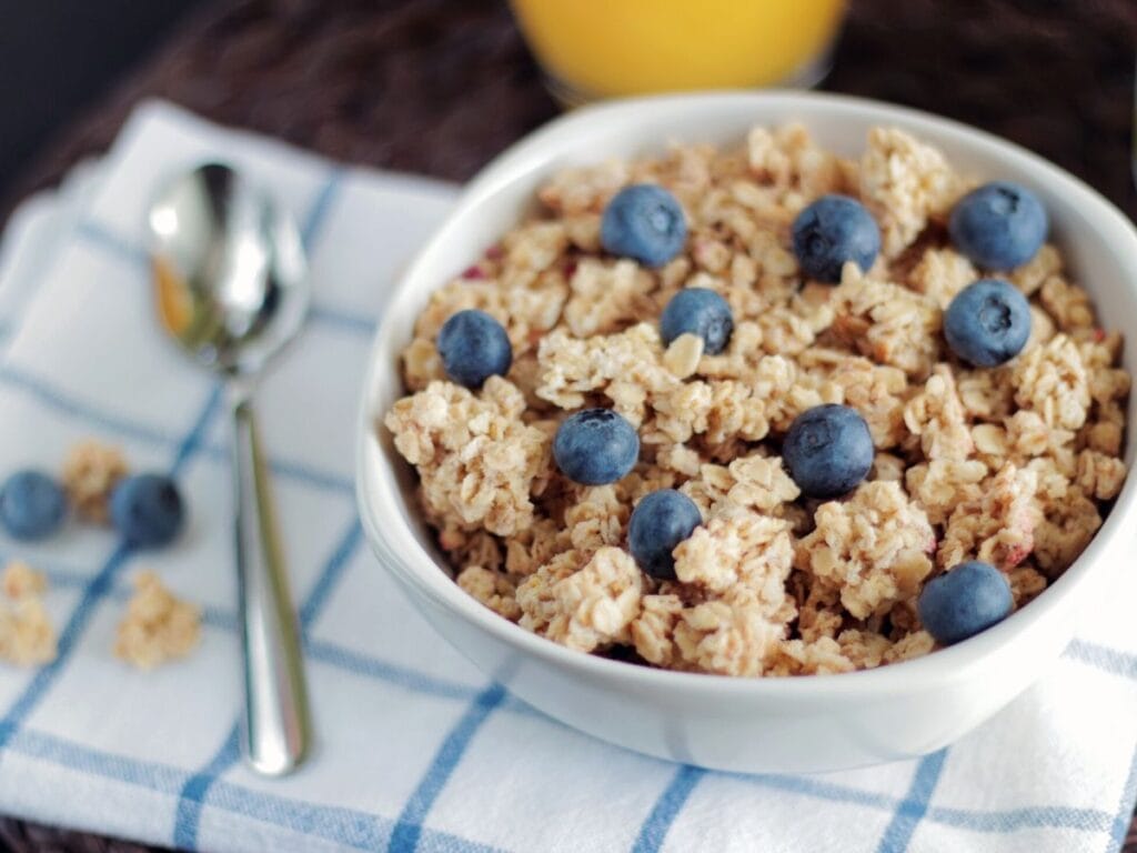 A bowl of oatmeal topped with blueberries.