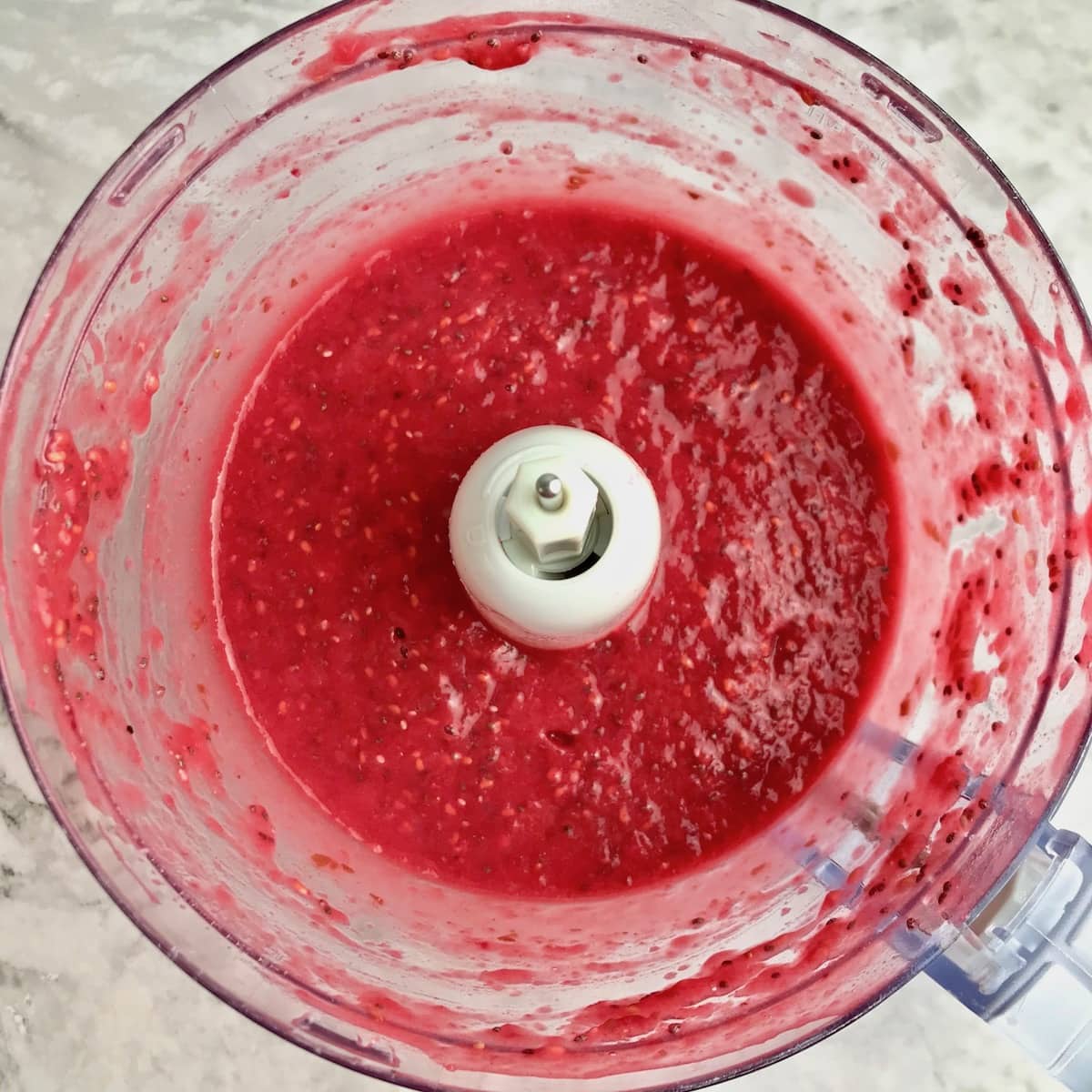 Red jam in a food processor. 