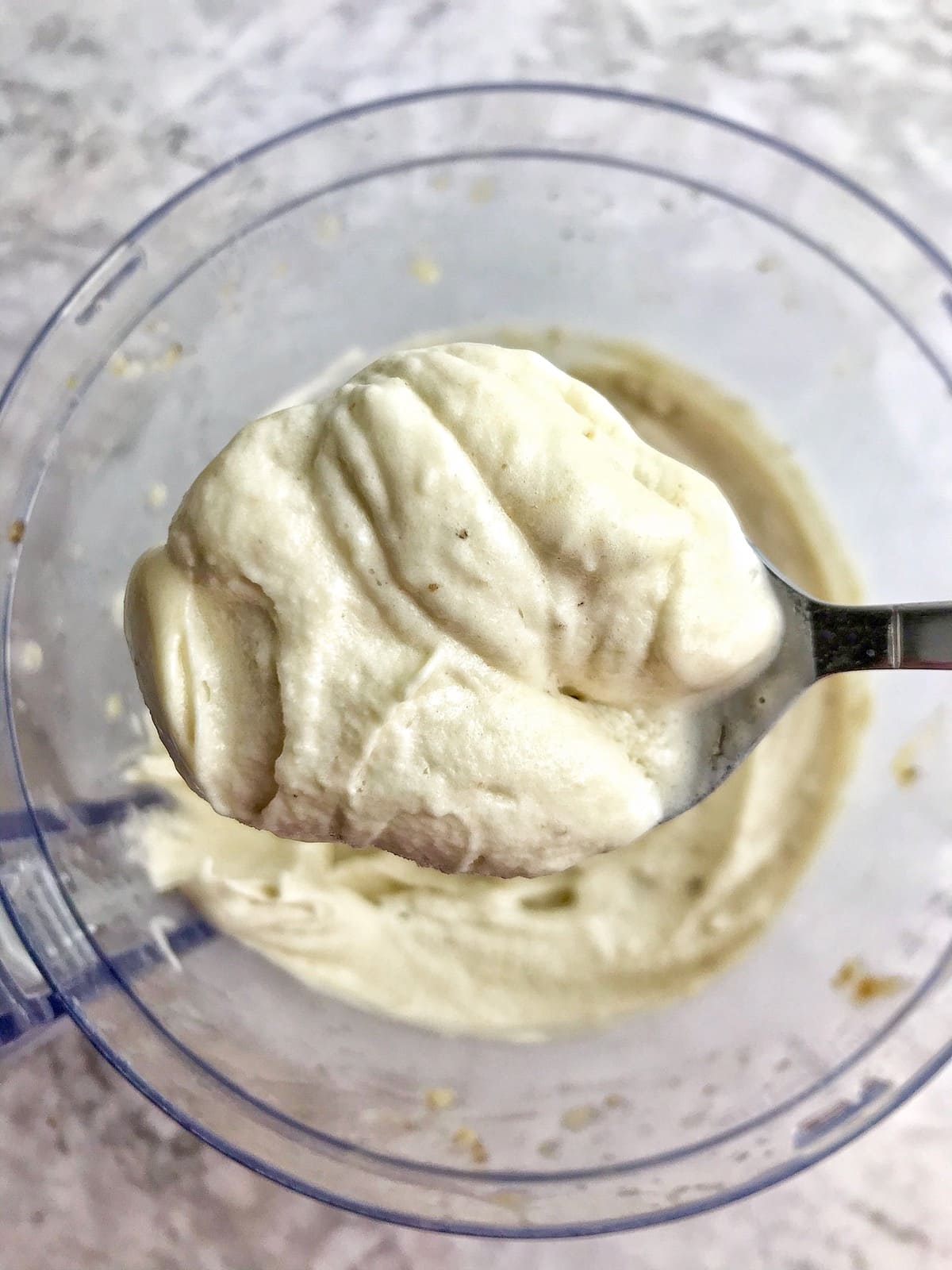 Spoonful of soft banana ice cream.