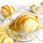 Banana ice cream in a bowl with caramel sauce on top.