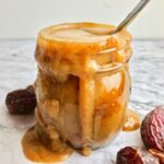 Vegan caramel sauce in a glass jar.