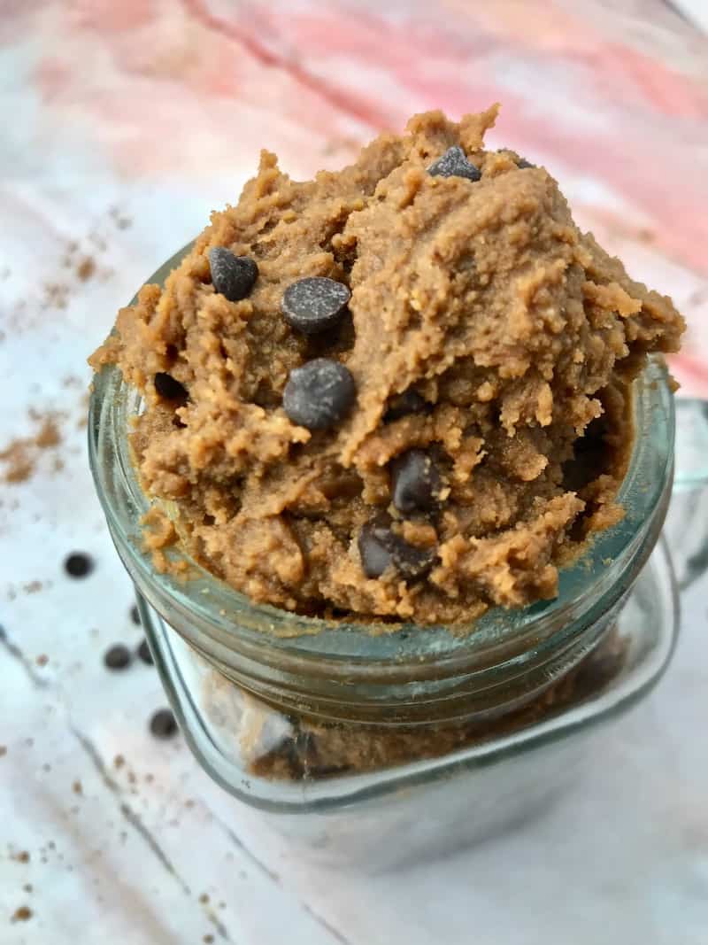 Chocolate chickpea cookie dough in a glass jar.