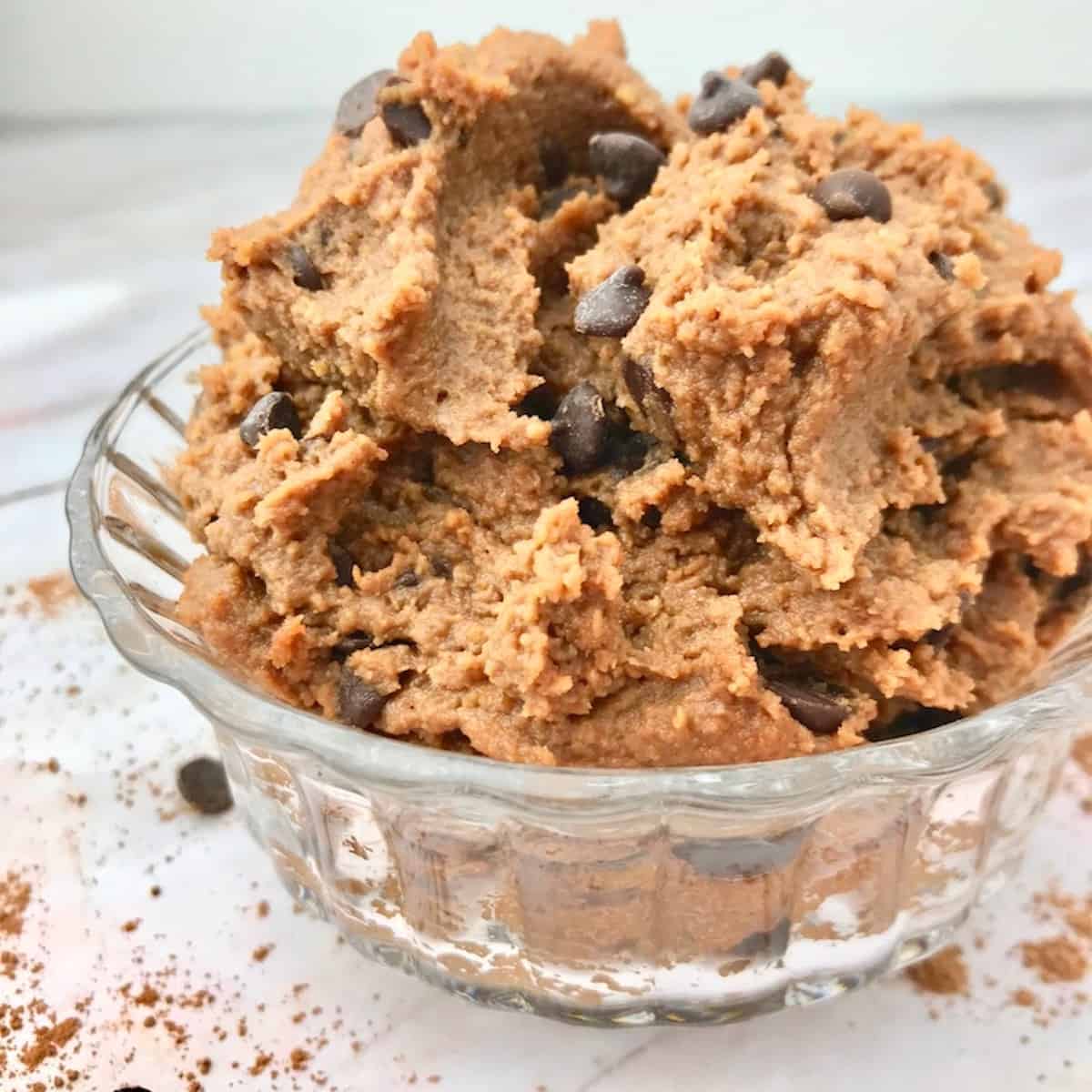 Chocolate chickpea cookie dough in a glass bowl.