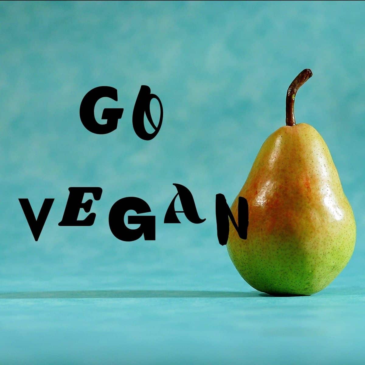 A pear next to text that says, "Go Vegan."