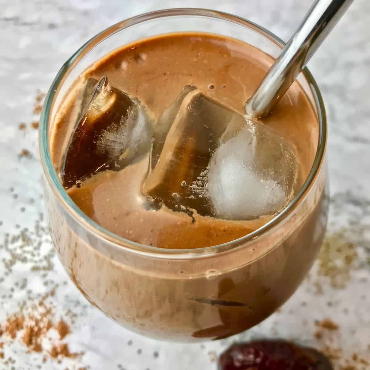 A coffee smoothie with ice in a glass.