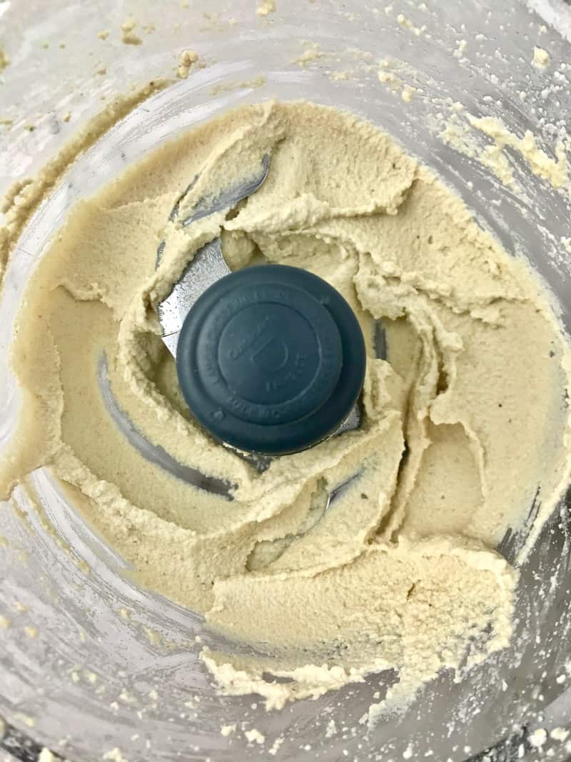 Blended cashew cream cheese in a food processor.