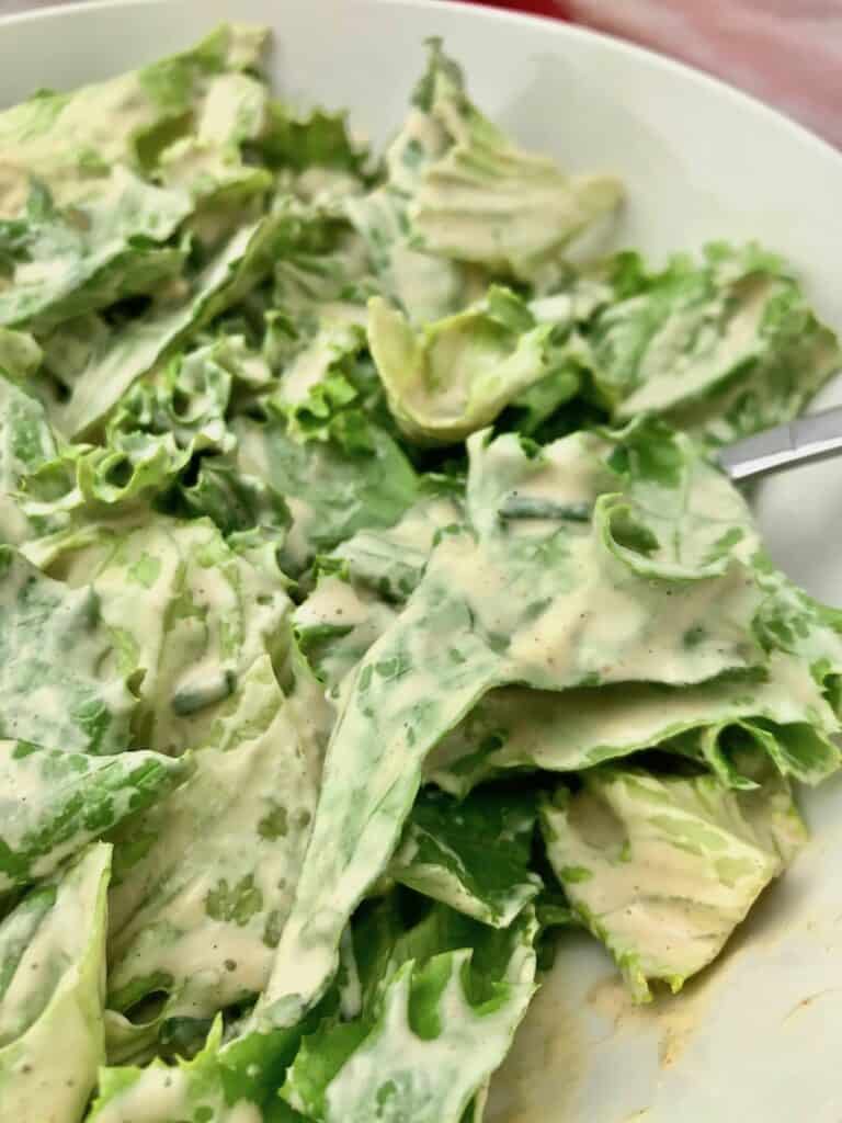 Creamy cashew dressing on lettuce.