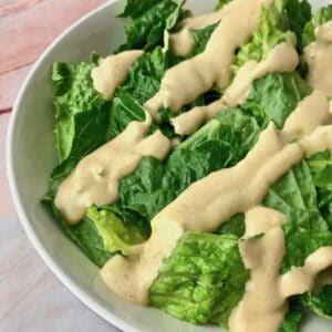 Creamy cashew dressing on a green salad.