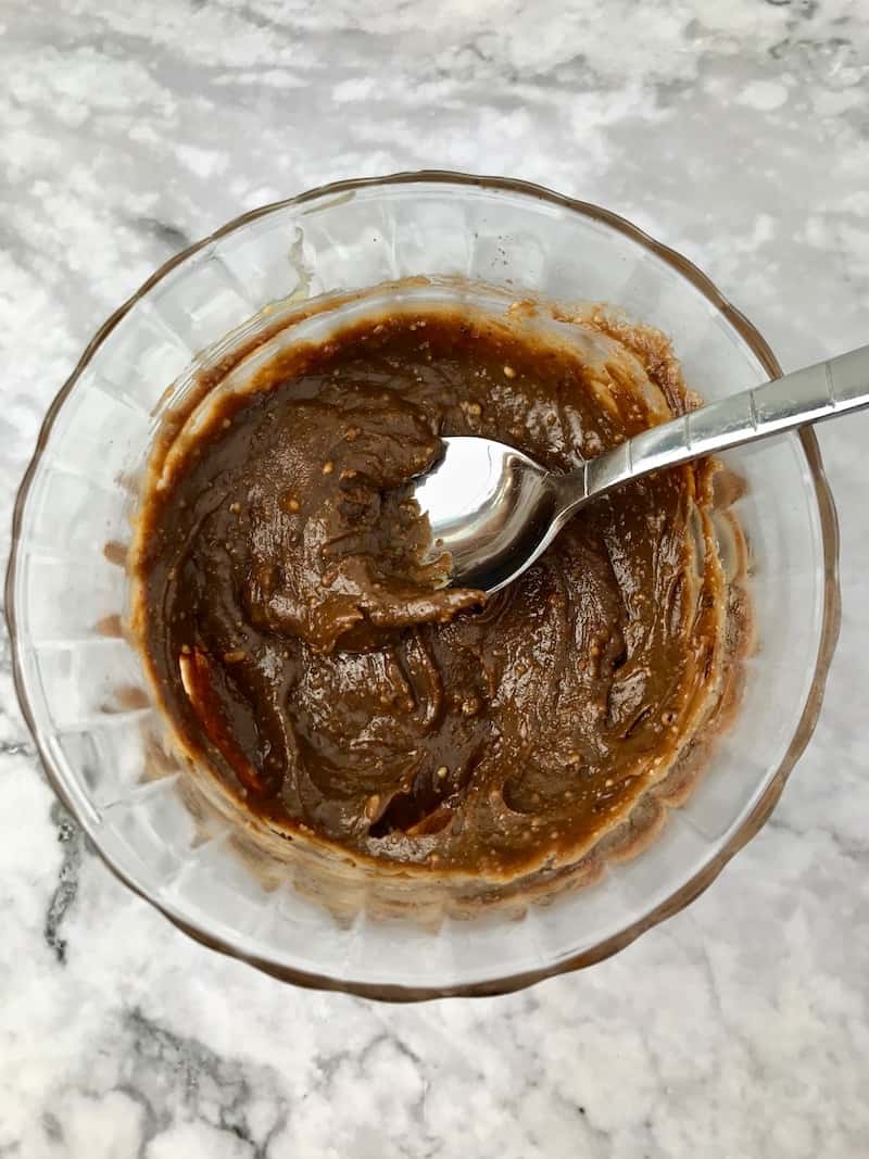 Chocolate peanut butter in a small bowl with a spoon.