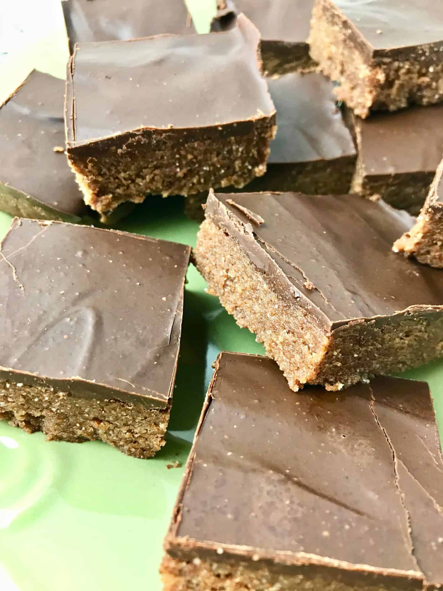 Numerous almond butter bars on a plate.
