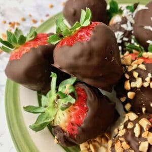 Chocolate covered strawberries on a plate.