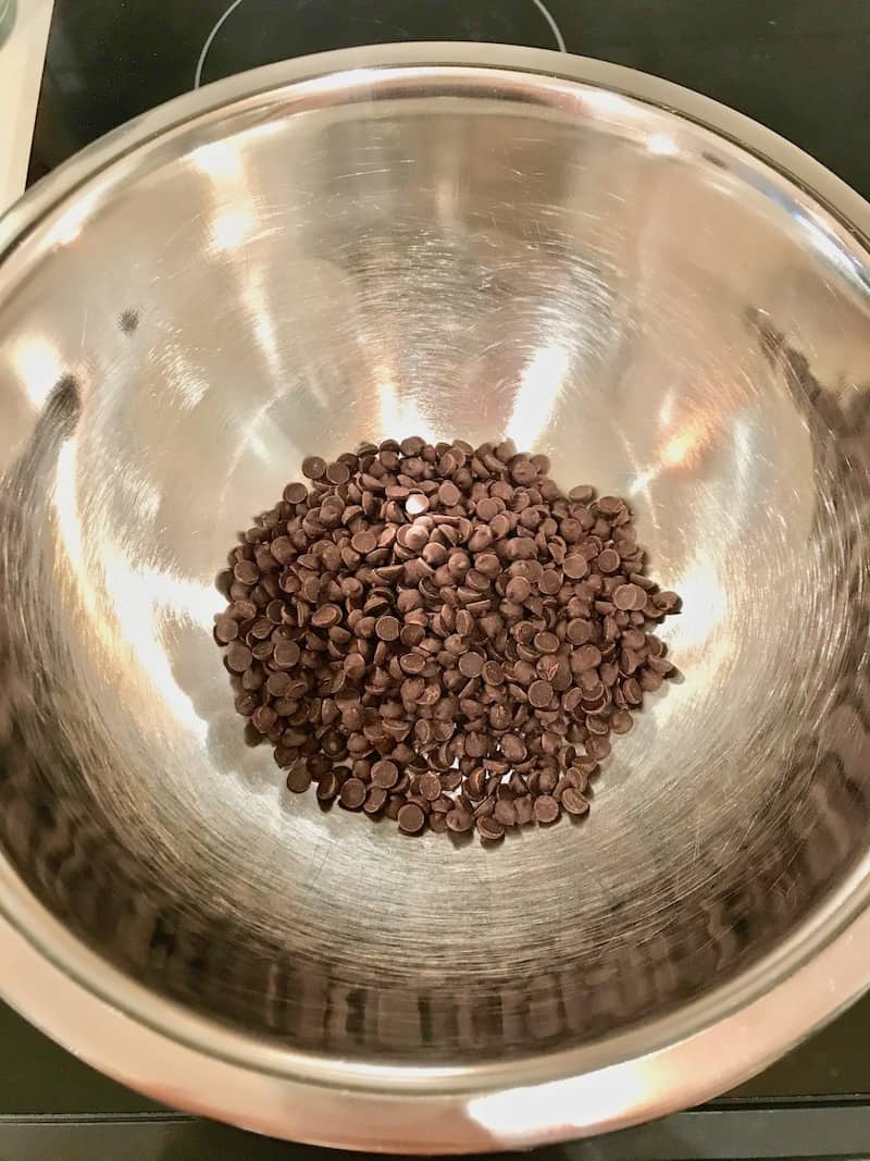 Chocolate chips in a stainless steel bowl.