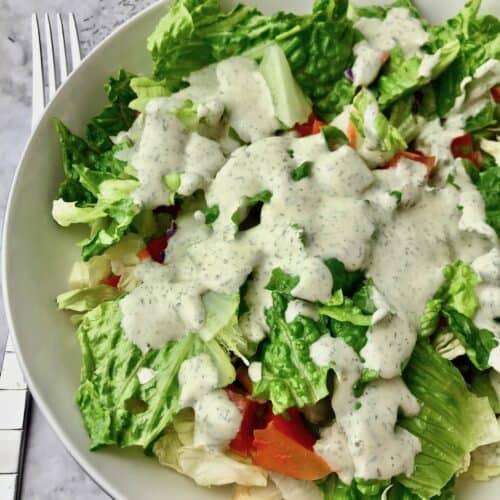 Creamy dill dressing on a green salad.