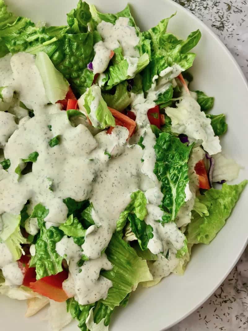 Creamy dill dressing on a green salad.