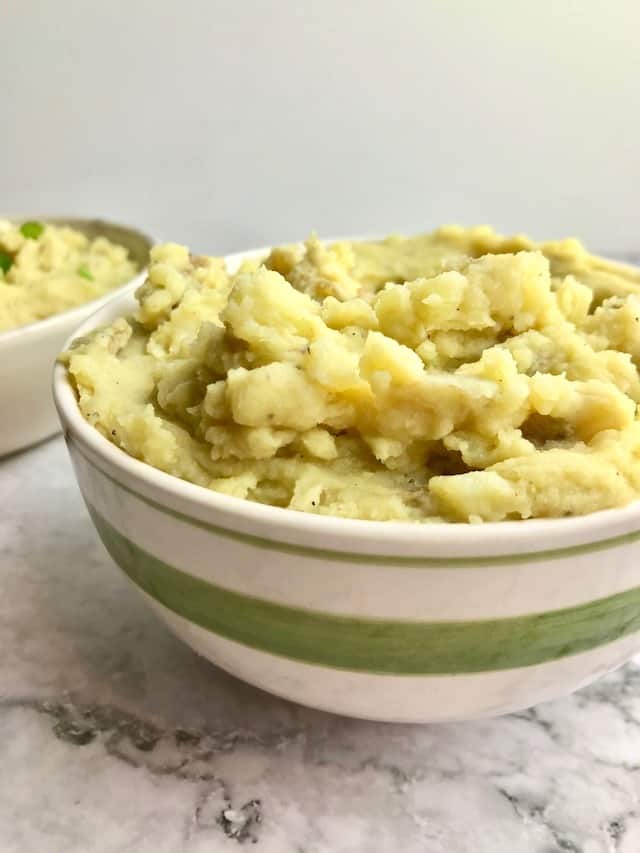 A bowl of yellow mashed potatoes.