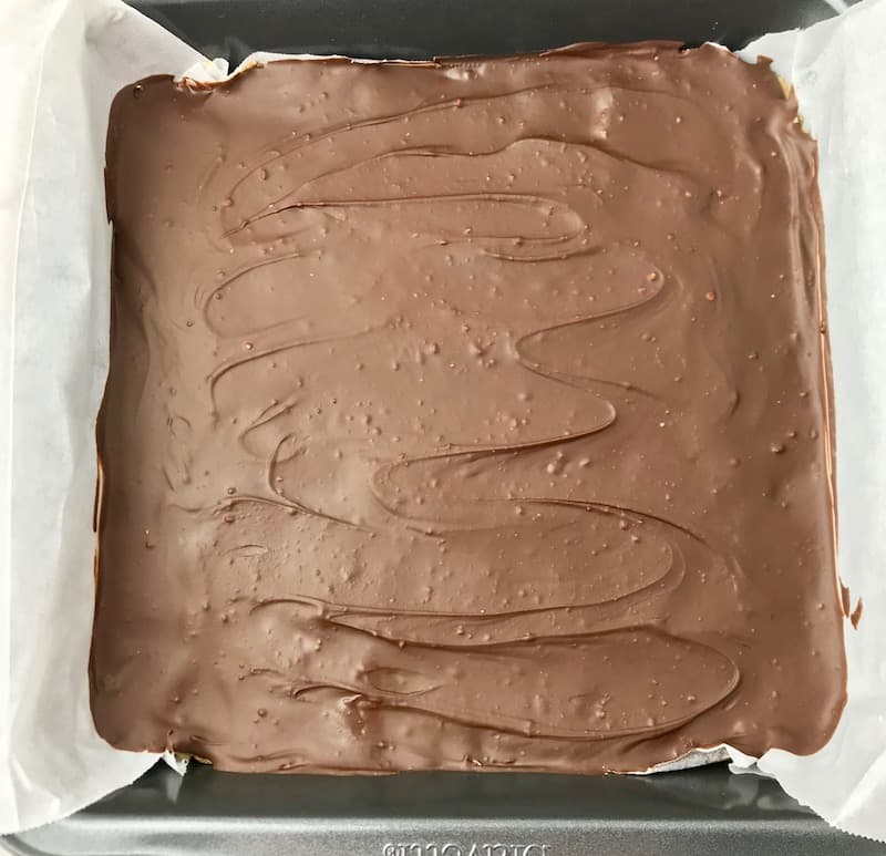 A dish of chocolate peanut butter bars that have been firmed up in the fridge.