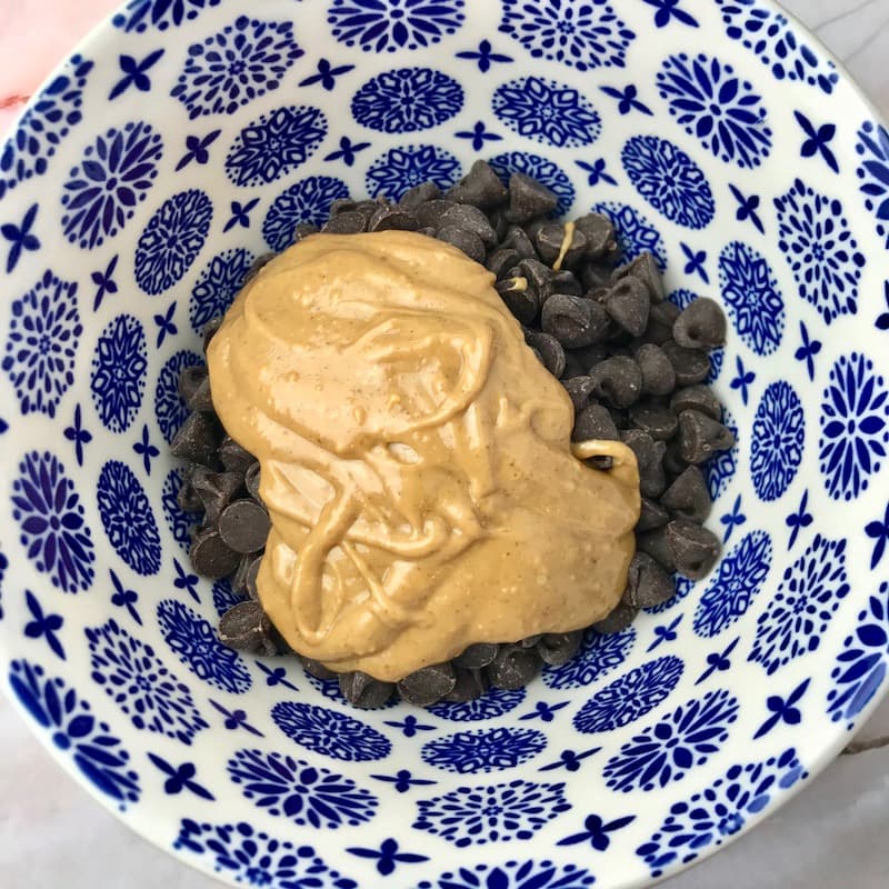 Chocolate chips and peanut butter in a bowl.