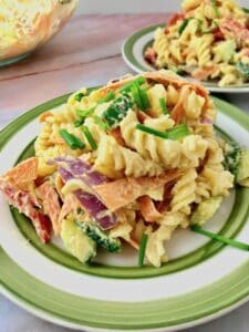 A plate of hummus pasta salad.