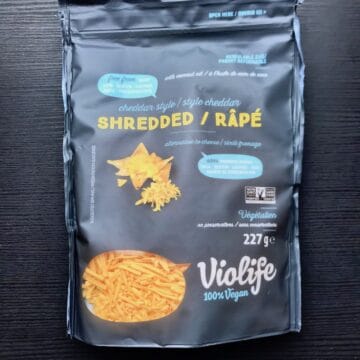 A package of Violife Cheddar Style vegan cheese shreds.