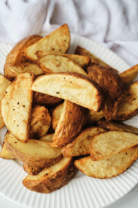 Potato wedges on a plate.