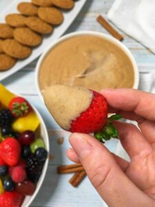 Gingerbread cheesecake dip on a strawberry.