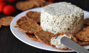 A garlic and herb almond vegan cheese spread with some crackers.