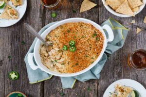 Jalapeno popper dip in a dish with a spoon in it.