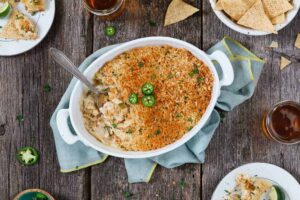 Jalapeno popper dip in a dish with a spoon in it.