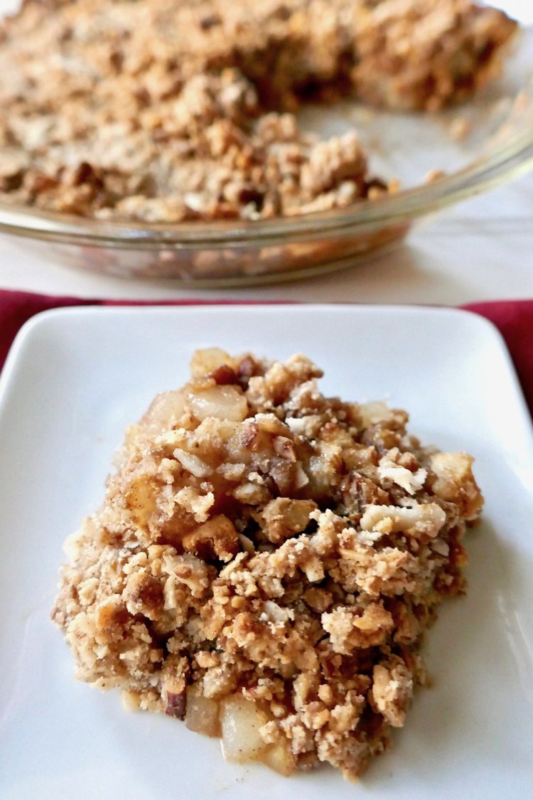 A piece of apple and pear crumble on a plate.