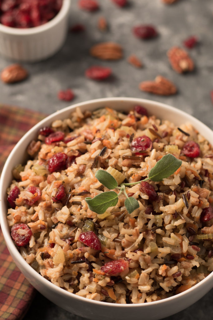 A bowl of wild rice pilaf with pecans and cranberries.