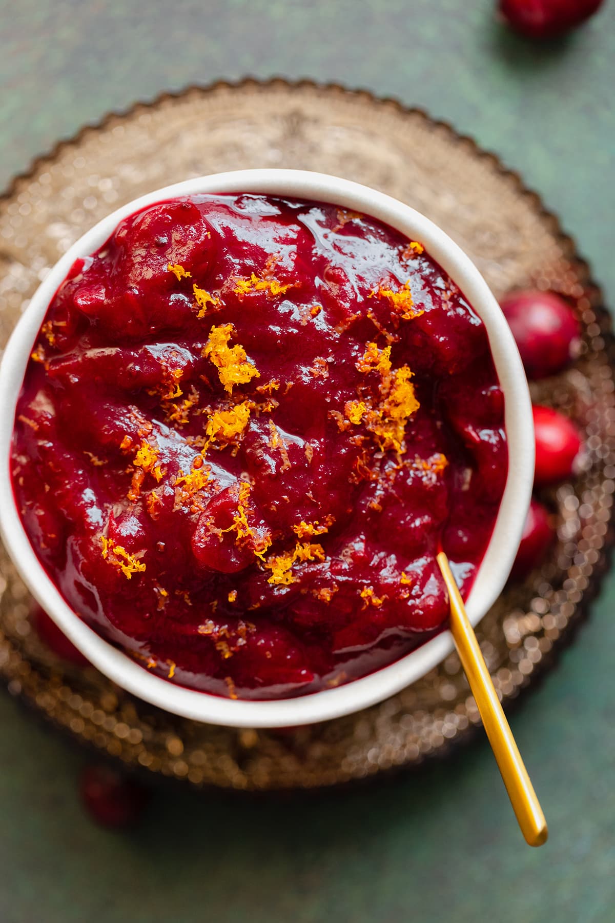 A bowl of orange cranberry sauce.