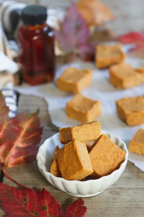 A bowl of pumpkin pie fudge, with some more in the background.