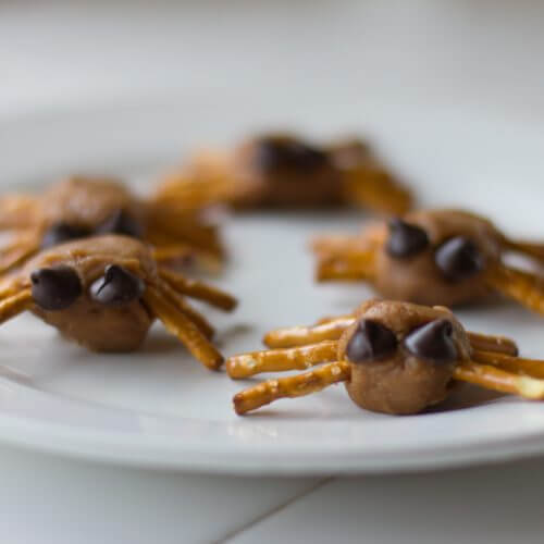 Peanut butter spider treats with pretzel legs and chocolate chip eyes.