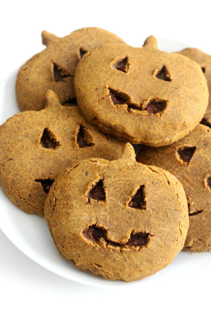 Pumpkin shaped cookies on a plate.