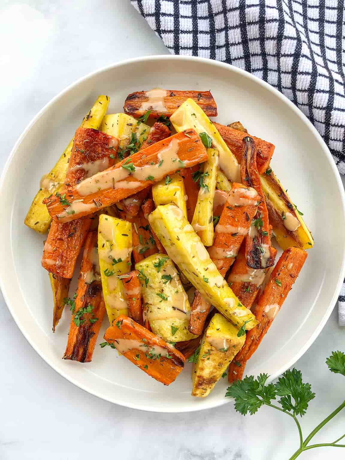 A plate of roasted carrots and pasnips.