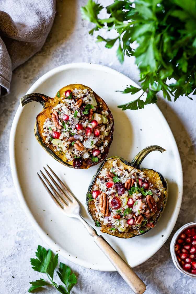 Two halves of an acorn squash stuffed with a rice mixture.