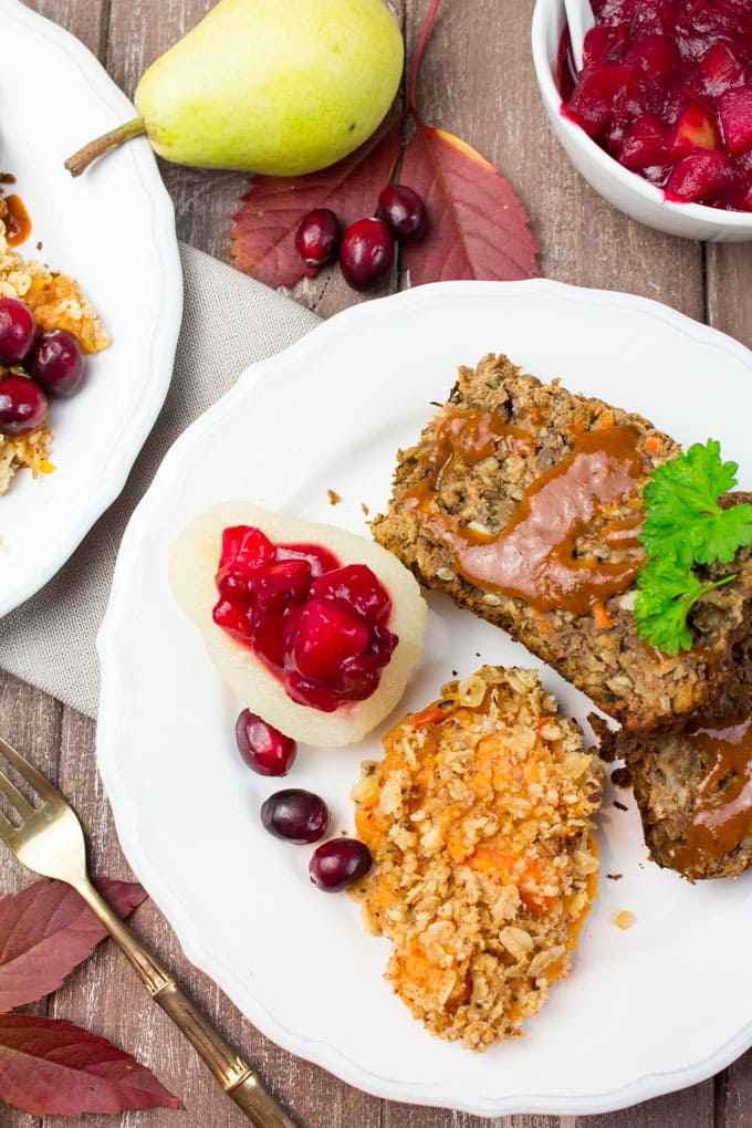 A Thanksgiving dinner plate of vegan lentil loaf, mashed sweet potatoes, and cranberry sauce.