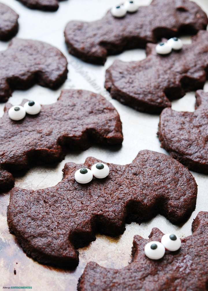 Chocolate sugar cookies in the shape of bats with candy eyes on them.