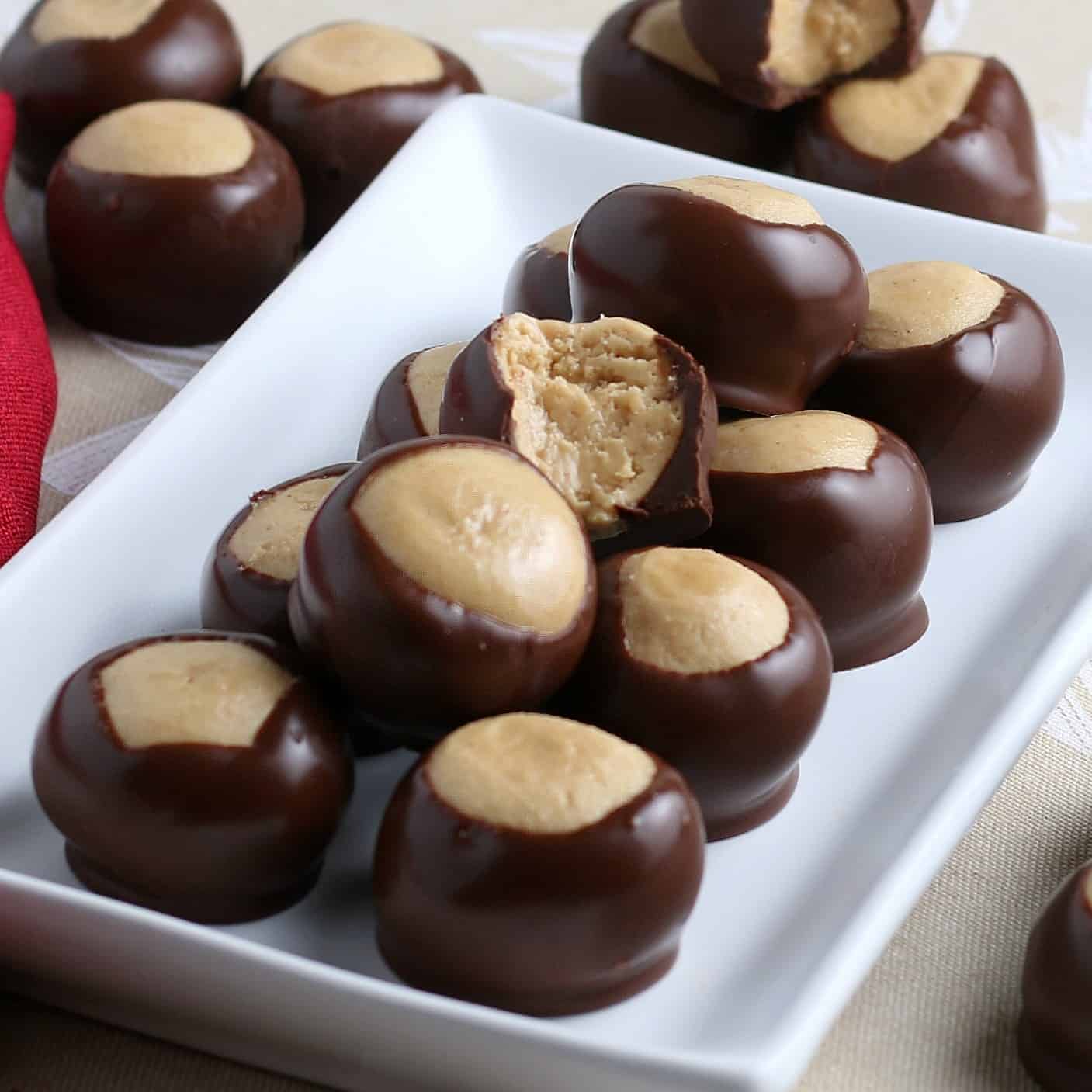 A plate of vegan peanut butter balls covered in chocolate.