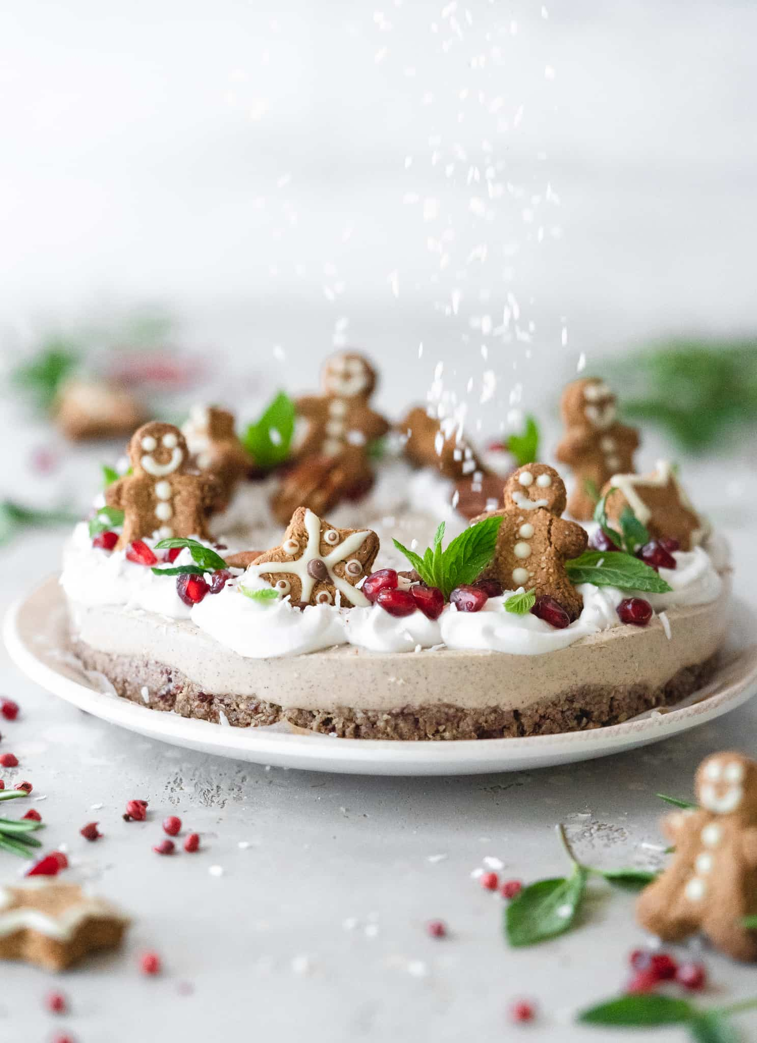 A vegan gingerbread cheesecake with gingerbread men cookies on it.