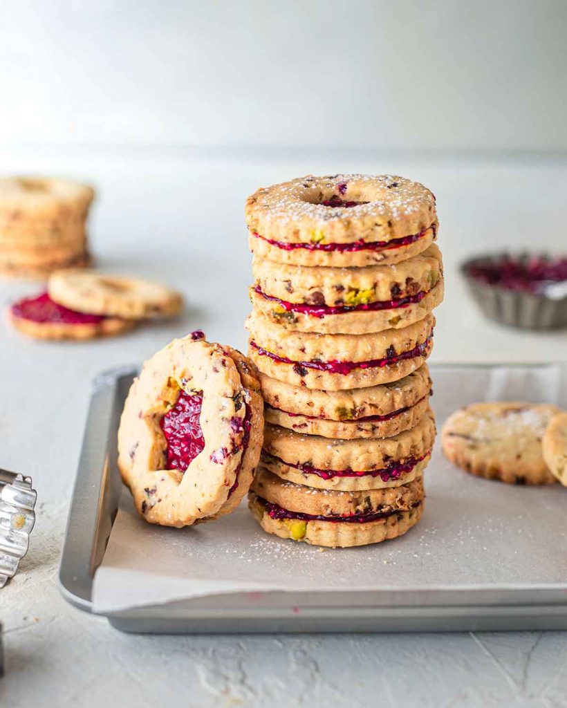 A stack of vegan cranberry and pistachio cookies.